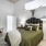 bedroom with green bedding and chair